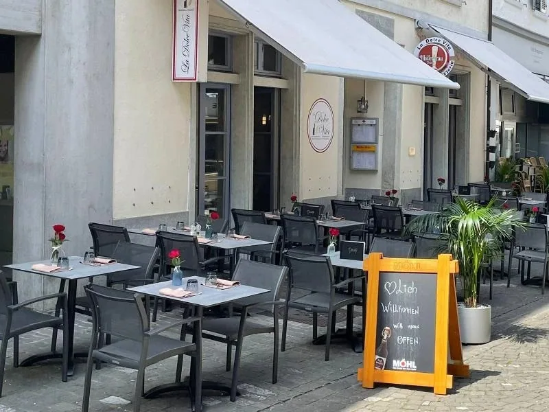 Aussentische mit roten Rosen auf der Terrasse an der Marktgasse.